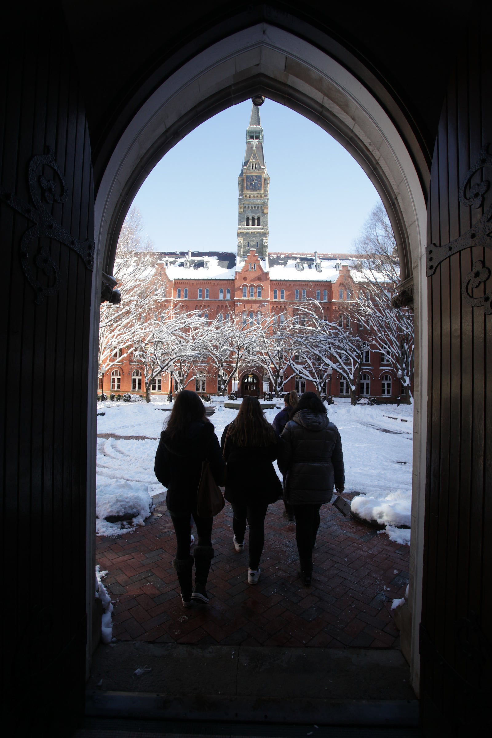 Georgetown employees walking through campus with snow on the ground